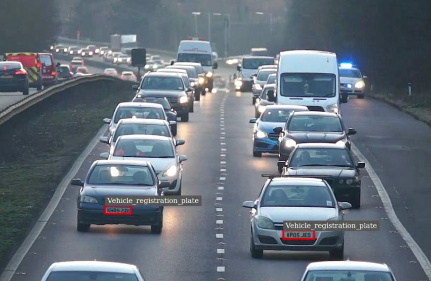 Motorway traffic with two vehicle registration plates detected and framed by the recognition software