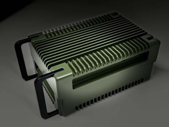 The Y9860A, an olive-green finned enclosure with two carrying handles