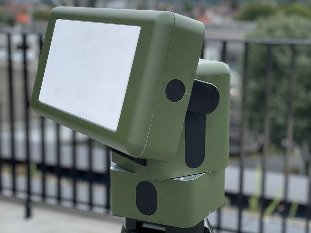 Y3010A radar head, olive green, mounted on a tripod on a terrace